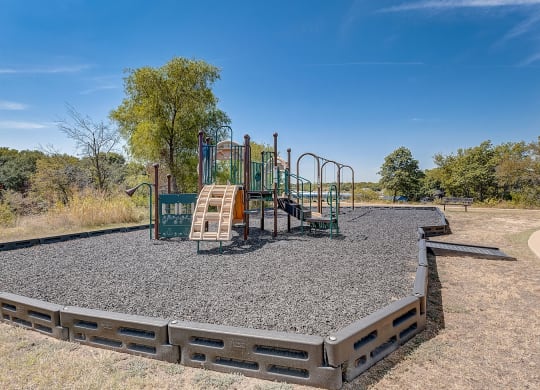 A playground in a park with a blue sky in the background at The Legends at Eagle Mountain Lake, Texas, 76179